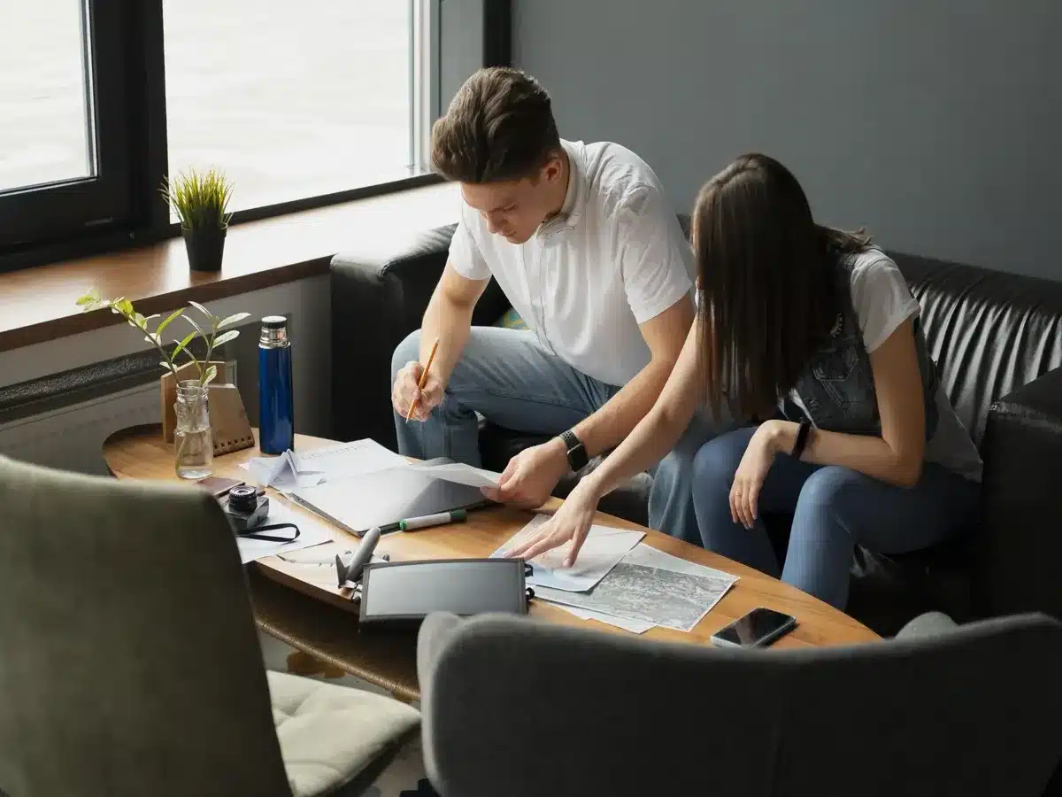 étudiants en recherche de solution de logement, avec des fiches et un ordinateur